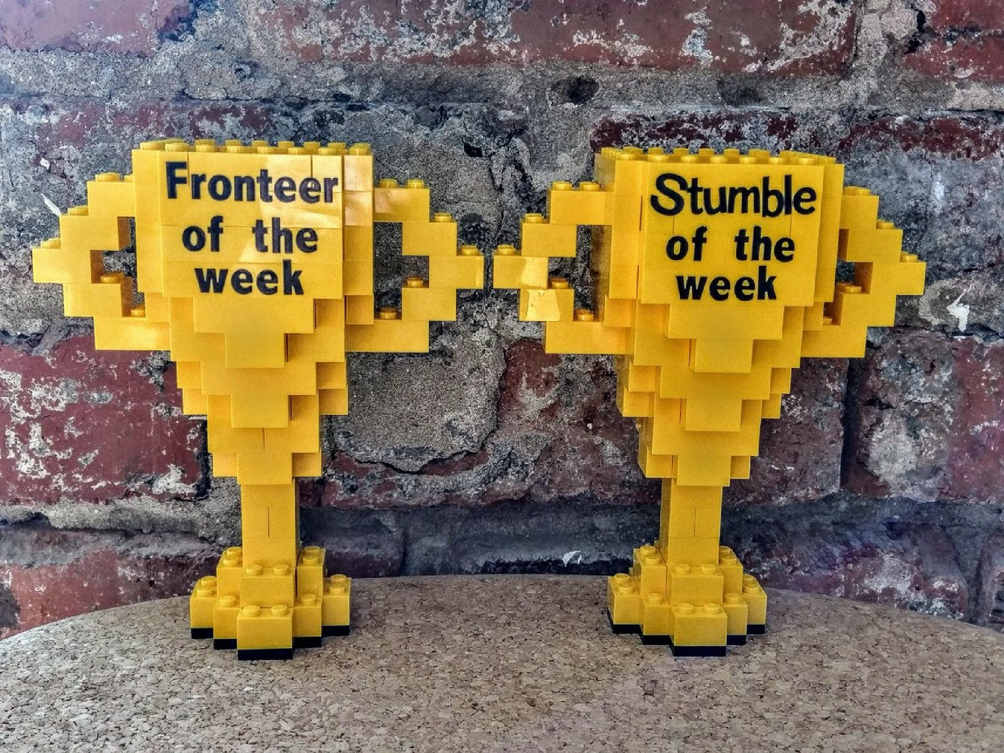 Fronteer of the Week and Stumble of the Week trophies crafted out of legos